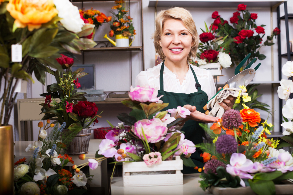 image of florist in shop. Concept of small buisness owner investing in marketing.