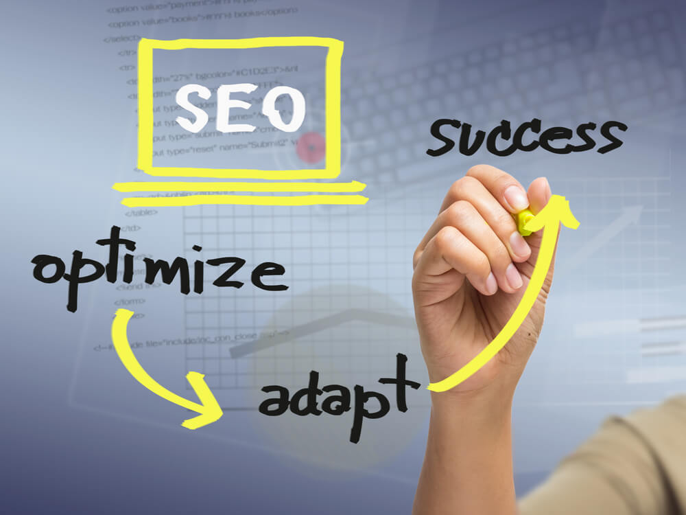 Hand Writing SEO Strategy Concept