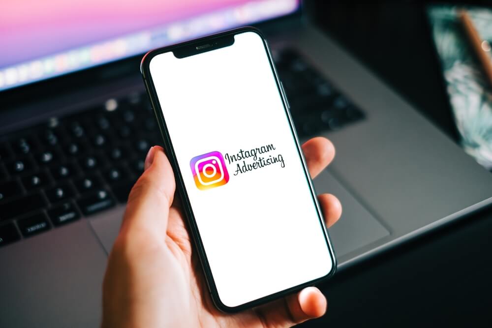 Instagram ads logo on the smartphone screen.